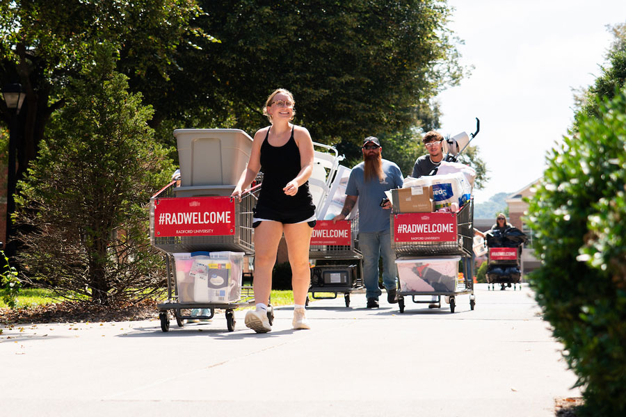 A Radford University student and an adult move her belongings into residential housing.