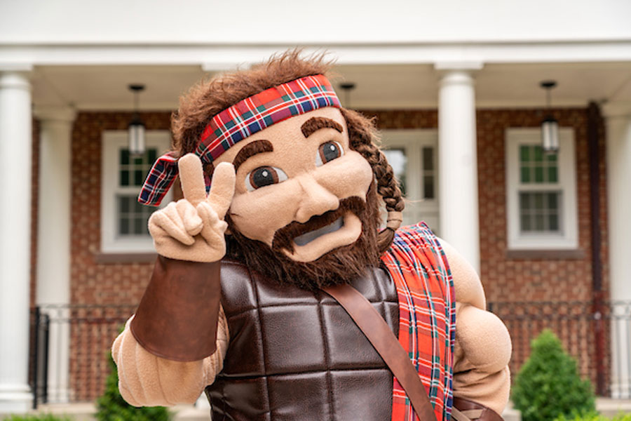 Radford University's mascot poses in front of a campus building.