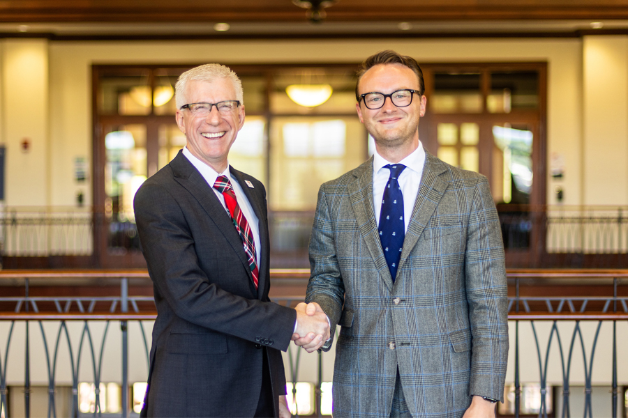 President Bret Danilowicz shakes hands with Tyler W. Lester in Kyle Hall at Radford University