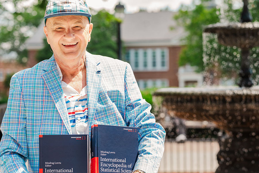 Associate Professor Miodrag Lovric with the International Encyclopedia of Statistical Science, Second Edition.