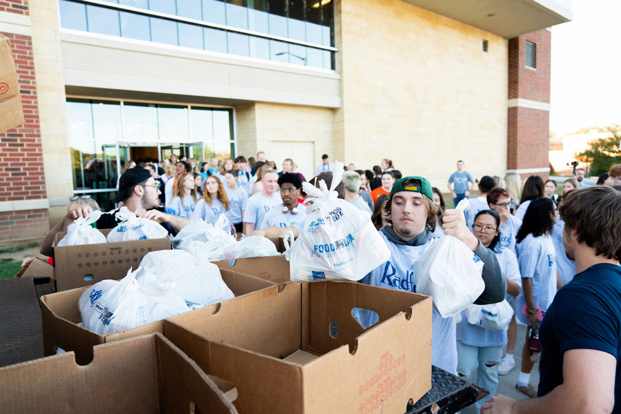 Students pack bags in boxes outside the event