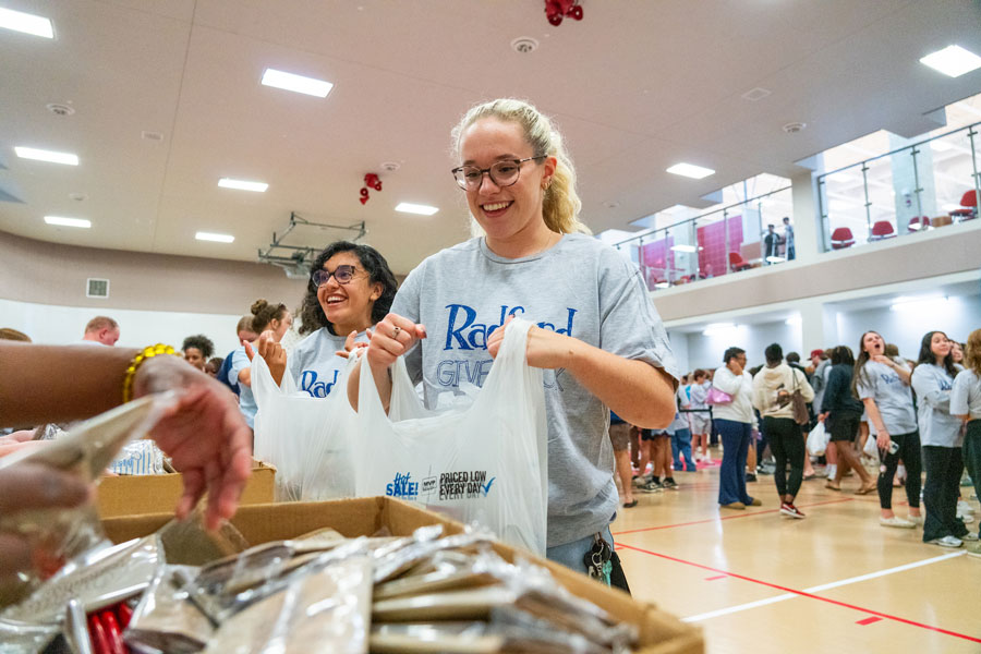students fill bags with donated items