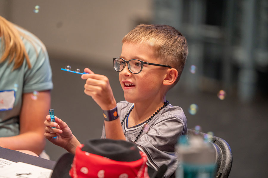 Boy playing with bubbles