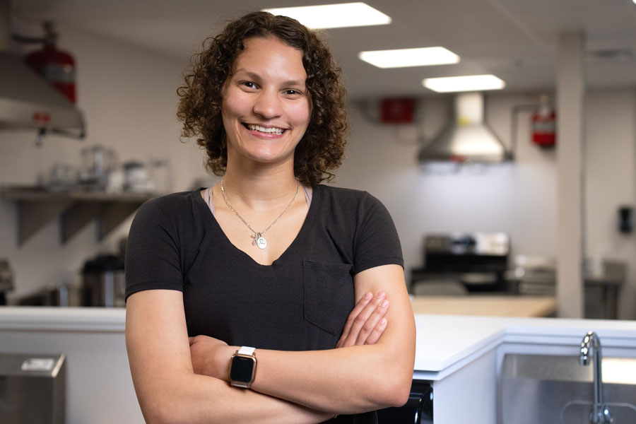 Foods and nutrition major Leah Ellis stands in a laboratory.