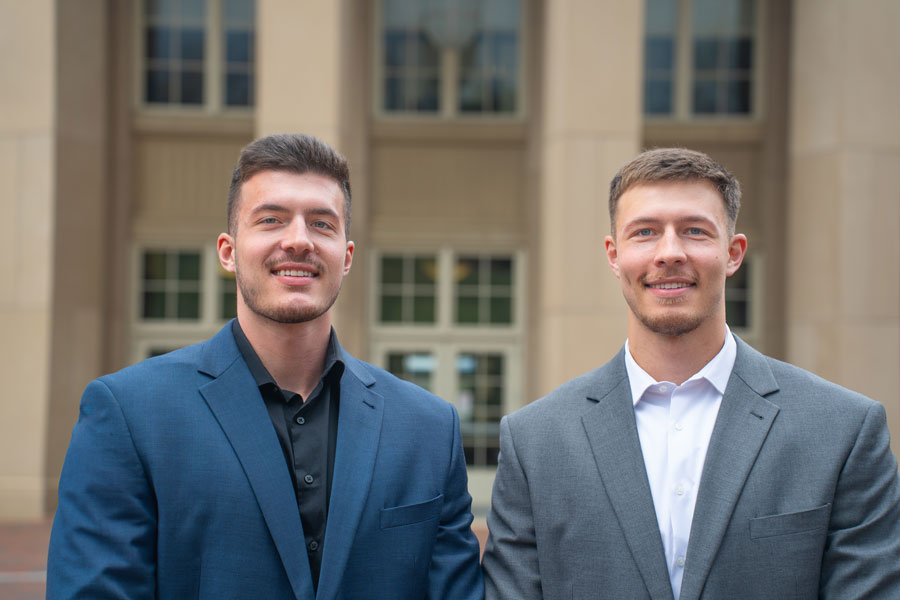 Brothers Brent Mabry and Reece Mabry stand together in front of Kyle Hall