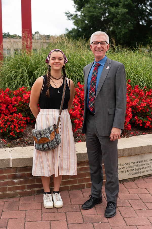 student Ruby Dowd with President Bret Danilowicz at red clocks