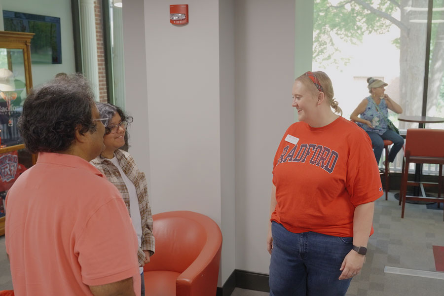 staff talk with students during early admission event
