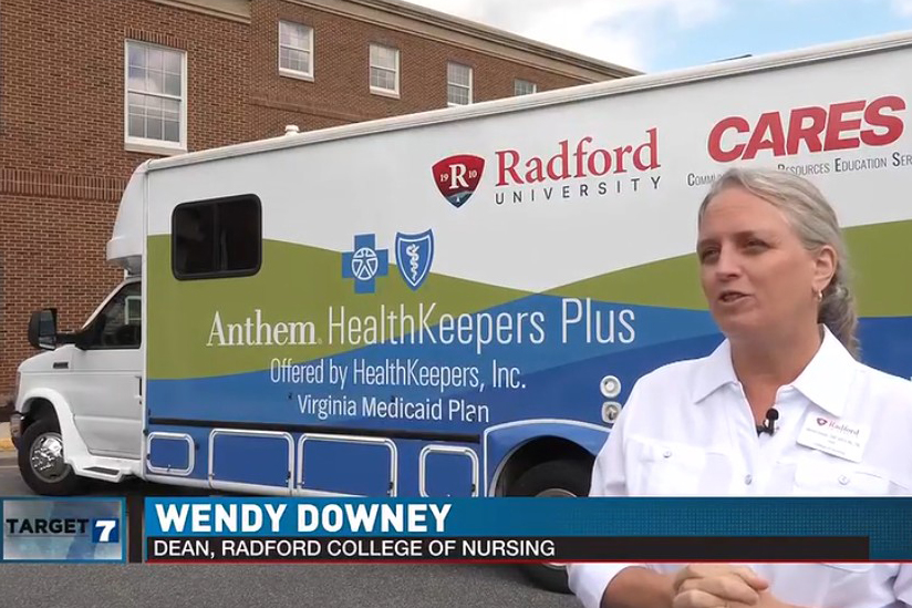 Nursind dean Wendy Downey stands in front of the Radford Cares mobile health clinic.