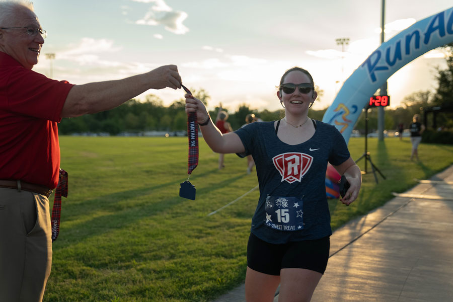 A Radford runner crosses the finish line of the third Tartan 5K