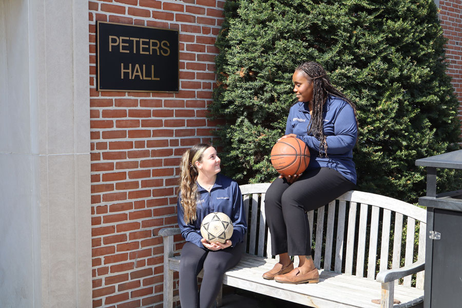 Student Reagan Adams and her faculty mentor Tiesha Martin sit outside Radford University's Peters Hall.