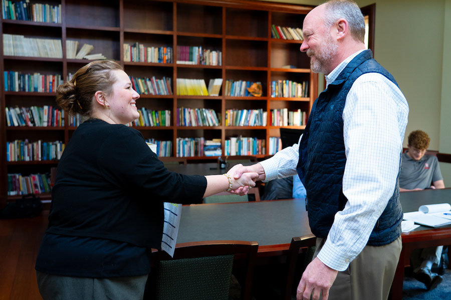 A Radford University student and a visiting alum shake hands during the Shadow Day 2026 meetings.