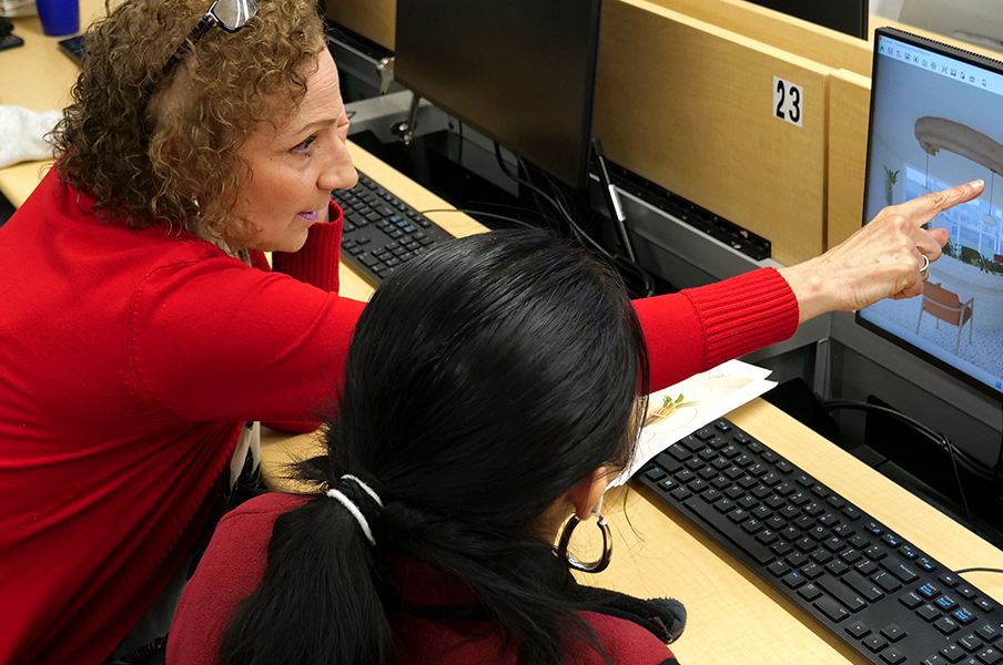 Professor Joan Dickinson works with student on a commercial design project