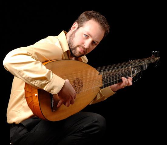 Musician Chris Wilke holds a Baroque lute.