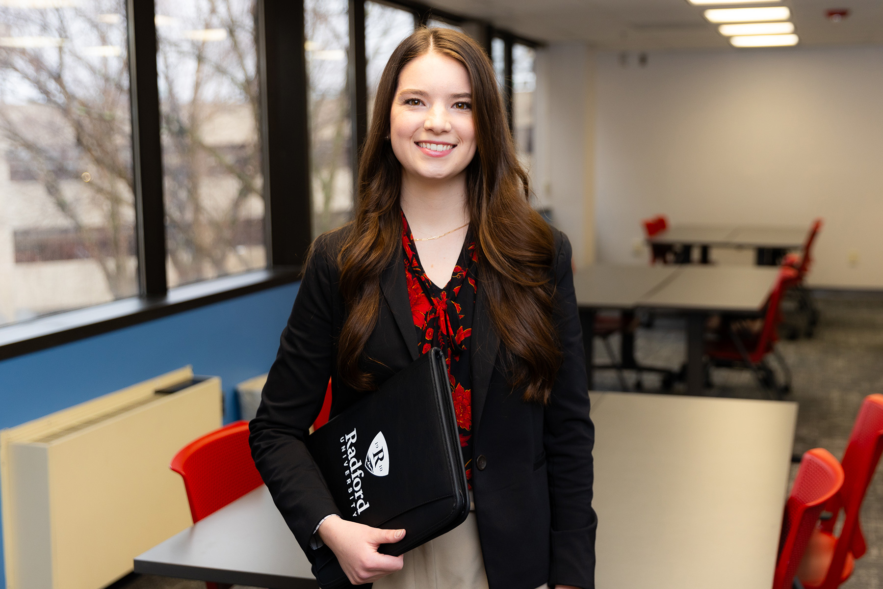 girl standing with notebook in hand