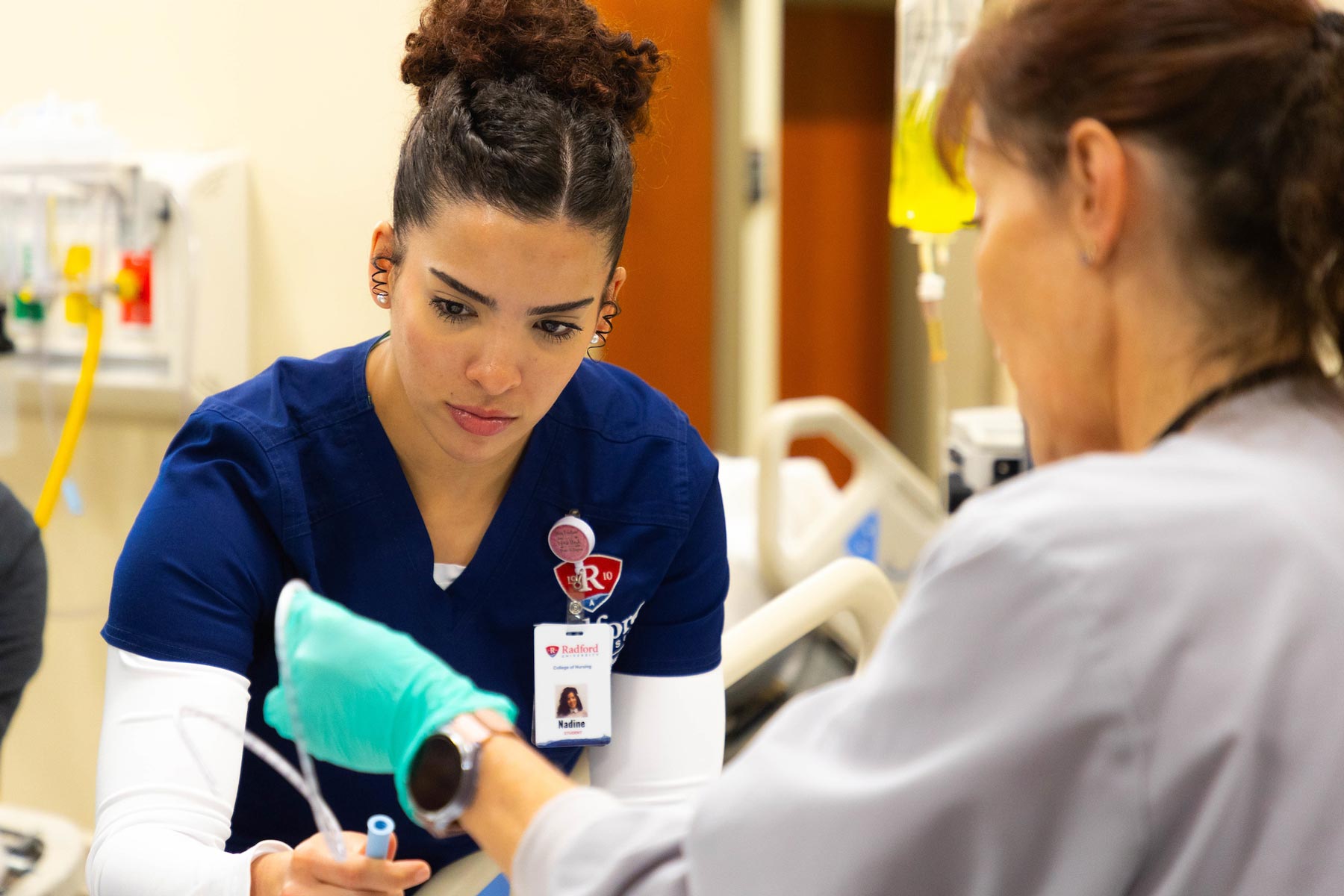 nursing student with professor in lab
