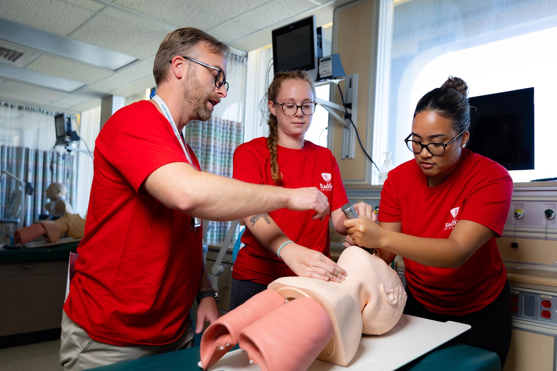 students with professor in respiratory therapy lab