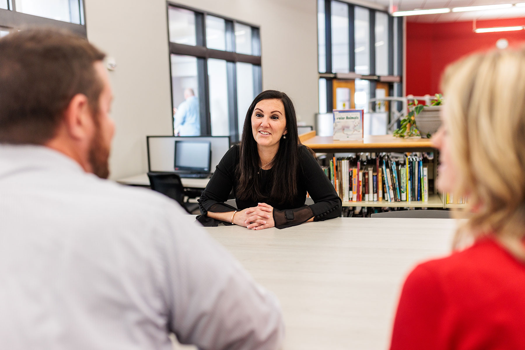 student talking to other students