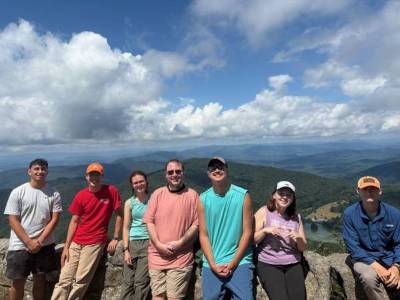 Students posing at the top of a hike