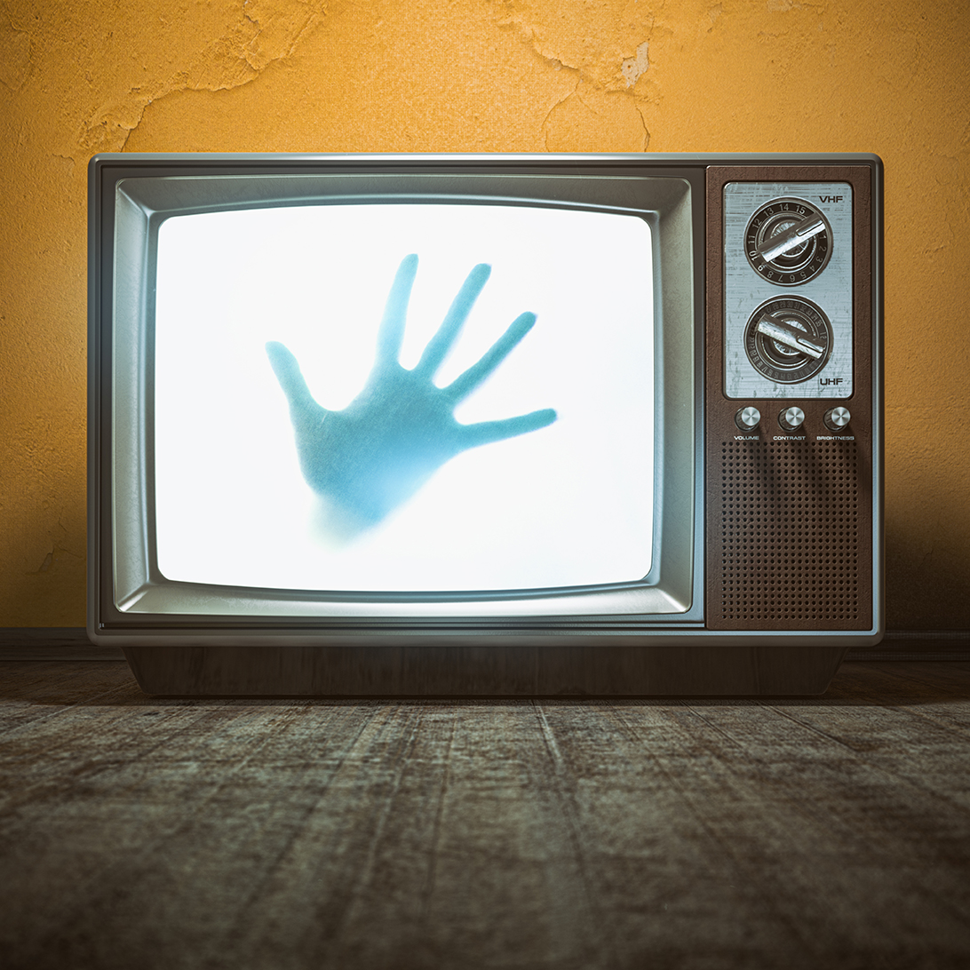 Silhouette Hand on Vintage Television Screen