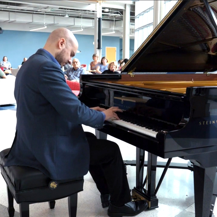 Professor Matthew Cataldi performing on piano in the Artis Center Performance Hub