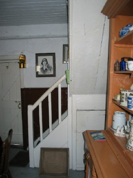 Stairs, entrance to the cellar, and the cup-board